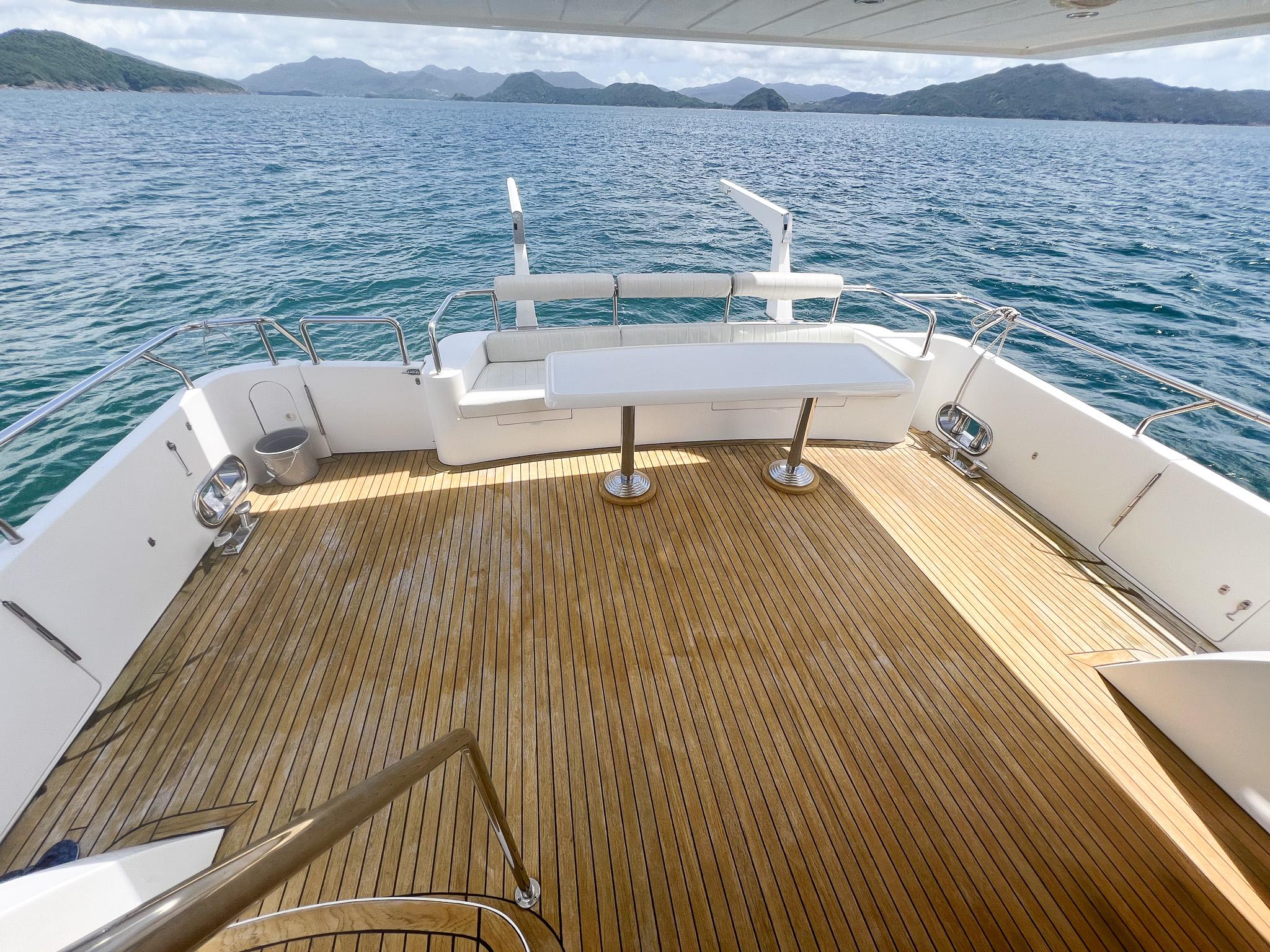 Spacious deck of 2005 Vitech 65 yacht with scenic ocean view.