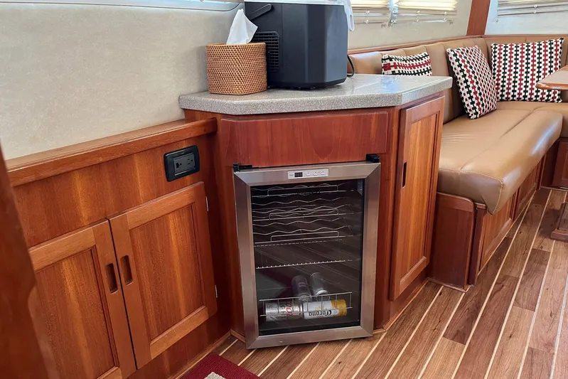 Dinky Dau Yacht Photos Pics Cozy interior of 2007 Nordic Tug 42 with wood cabinetry and mini fridge.