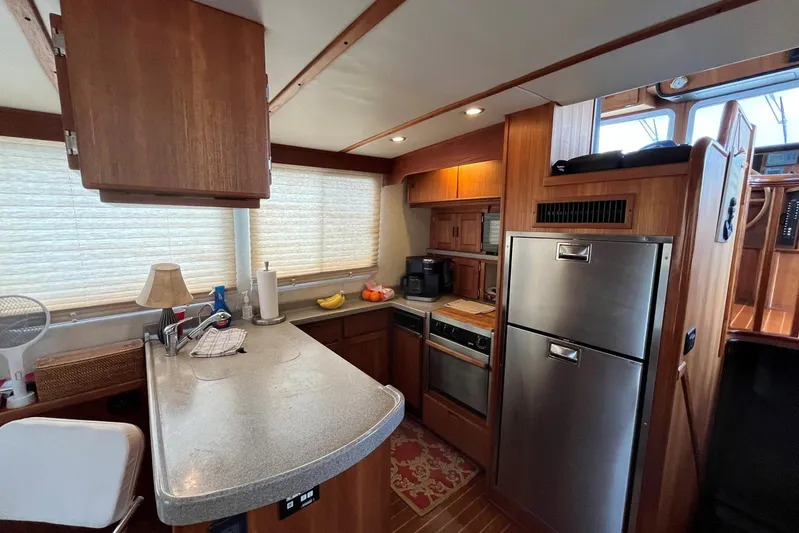 Dinky Dau Yacht Photos Pics Cozy kitchen interior of 2007 Nordic Tug 42 with wooden cabinetry and modern appliances.