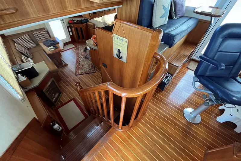 Dinky Dau Yacht Photos Pics Interior of 2007 Nordic Tug 42 with wooden flooring and seating area.