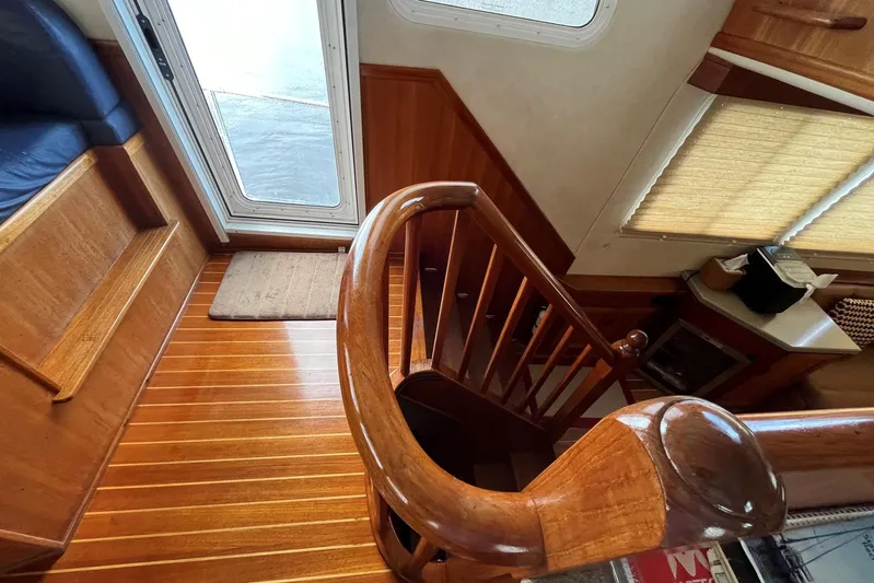 Dinky Dau Yacht Photos Pics Interior of 2007 Nordic Tug 42 with polished wooden staircase and seating area.