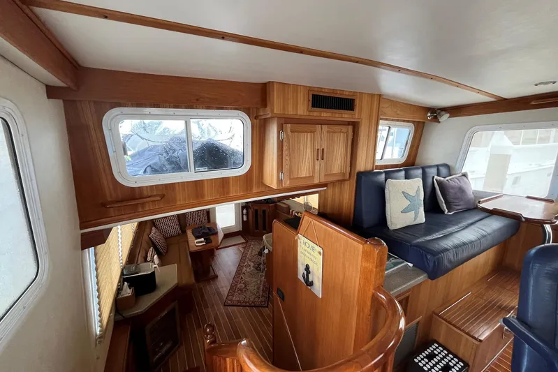 Dinky Dau Yacht Photos Pics Interior of 2007 Nordic Tug 42, featuring wood paneling and cozy seating area.