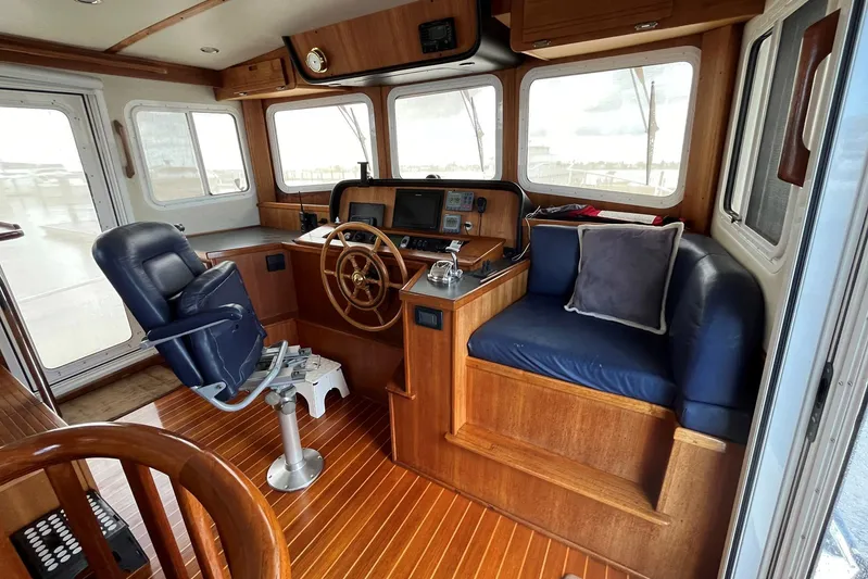 Dinky Dau Yacht Photos Pics Pilothouse of 2007 Nordic Tug 42 with wooden interior and navigation equipment.