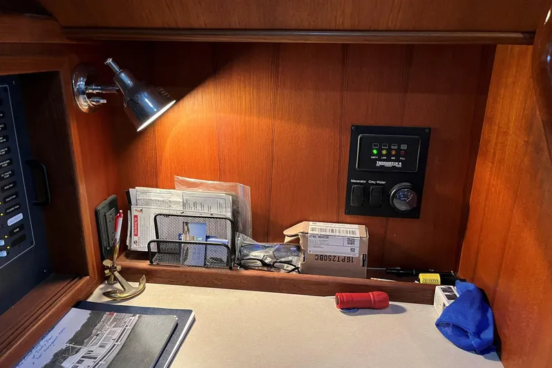 Dinky Dau Yacht Photos Pics 2007 Nordic Tug 42 interior with control panel, desk lamp, and organized documents.