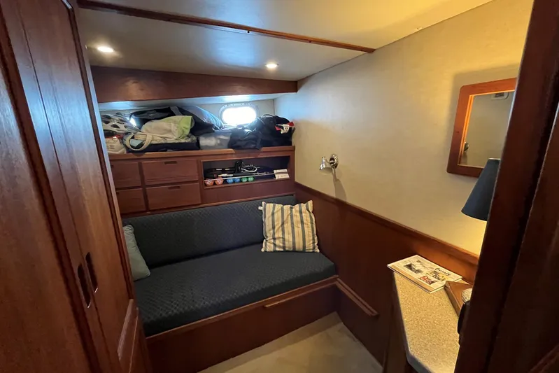 Dinky Dau Yacht Photos Pics Cozy cabin interior of 2007 Nordic Tug 42 with sofa, storage, and reading lamp.