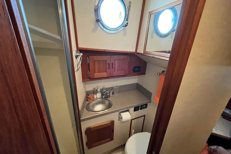 Dinky Dau Yacht Photos Pics Bathroom interior of 2007 Nordic Tug 42 with sink, toilet, and porthole window.