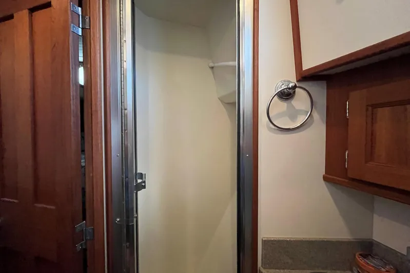 Dinky Dau Yacht Photos Pics Interior of 2007 Nordic Tug 42 bathroom with wooden cabinetry and shower.