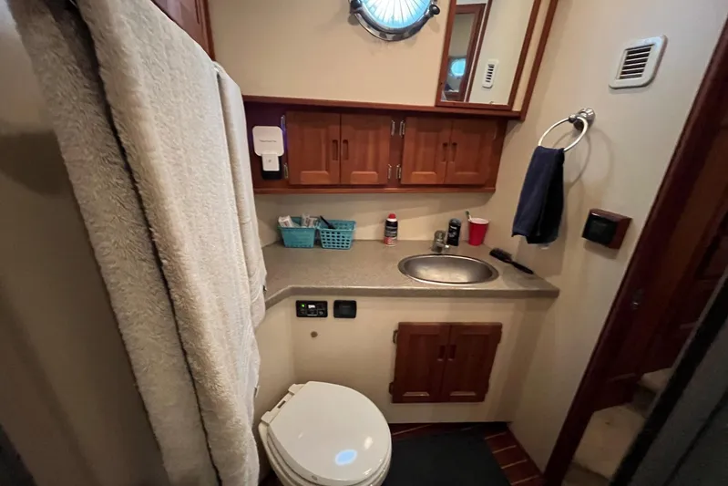 Dinky Dau Yacht Photos Pics Bathroom interior of 2007 Nordic Tug 42 with sink, toilet, and wooden cabinets.