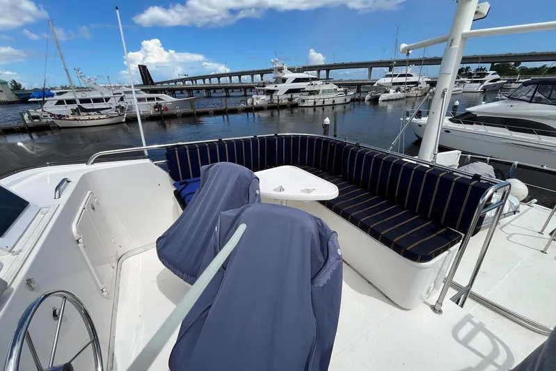 Dinky Dau Yacht Photos Pics 2007 Nordic Tug 42 yacht deck with seating, marina view, and blue sky.