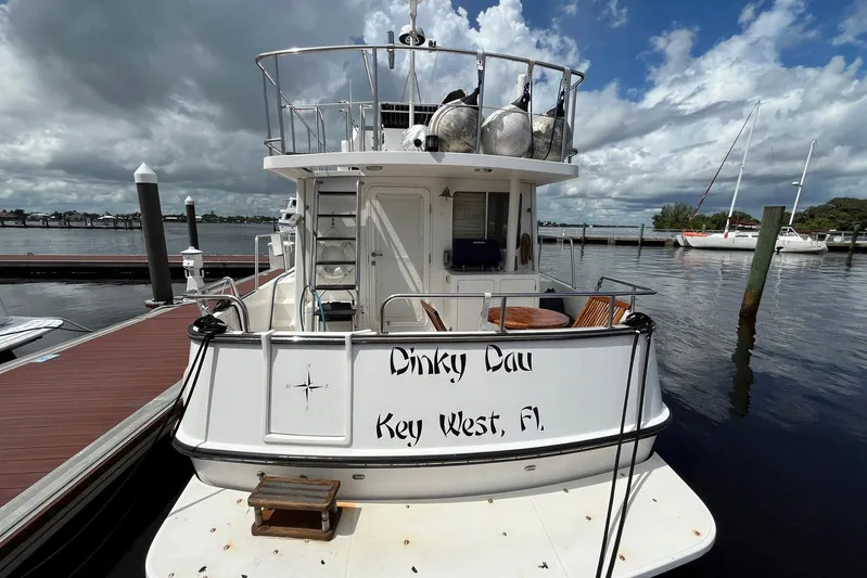 Dinky Dau Yacht Photos Pics 2007 Nordic Tug 42 docked in Key West, Florida under a cloudy sky.