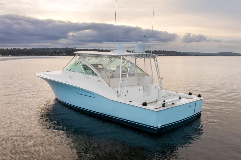  Yacht Photos Pics 2006 Cabo 40 Express boat on calm water at sunset.
