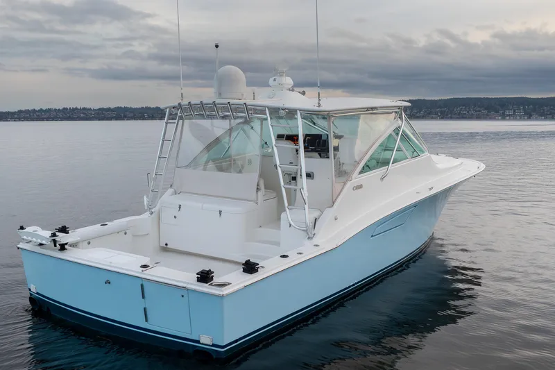  Yacht Photos Pics 2006 Cabo 40 Express boat on calm water under cloudy sky.