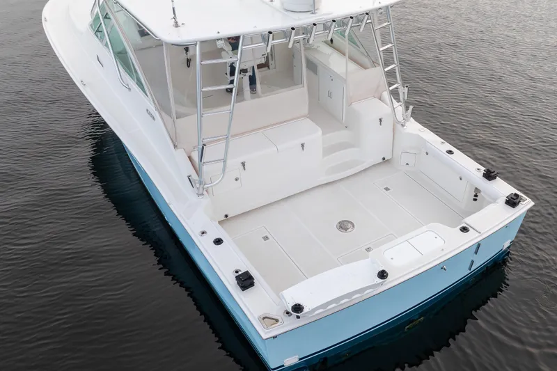  Yacht Photos Pics 2006 Cabo 40 Express boat on calm water, featuring spacious deck and sleek design.