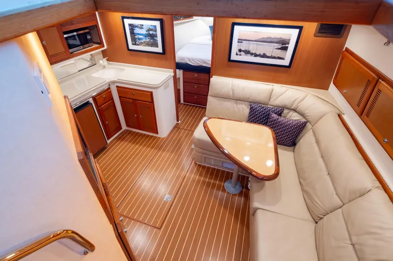  Yacht Photos Pics Luxurious 2006 Cabo 40 Express yacht interior with kitchen and seating area.