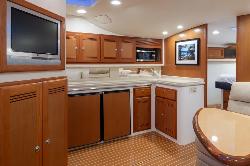  Yacht Photos Pics Luxurious 2006 Cabo 40 Express yacht interior with wood cabinetry and modern amenities.