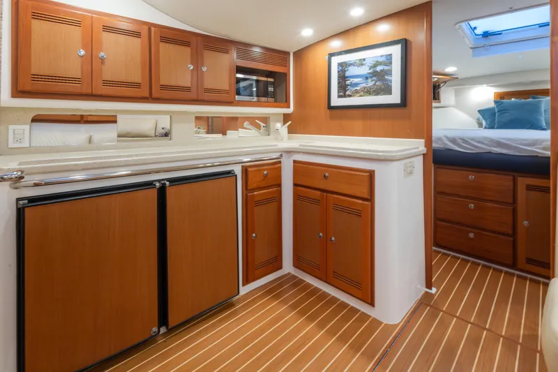  Yacht Photos Pics Luxurious 2006 Cabo 40 Express yacht interior with wood cabinetry and modern amenities.