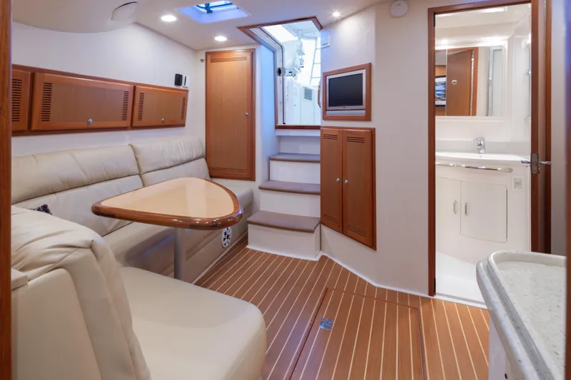  Yacht Photos Pics Luxurious interior of 2006 Cabo 40 Express yacht with elegant wood finishes.