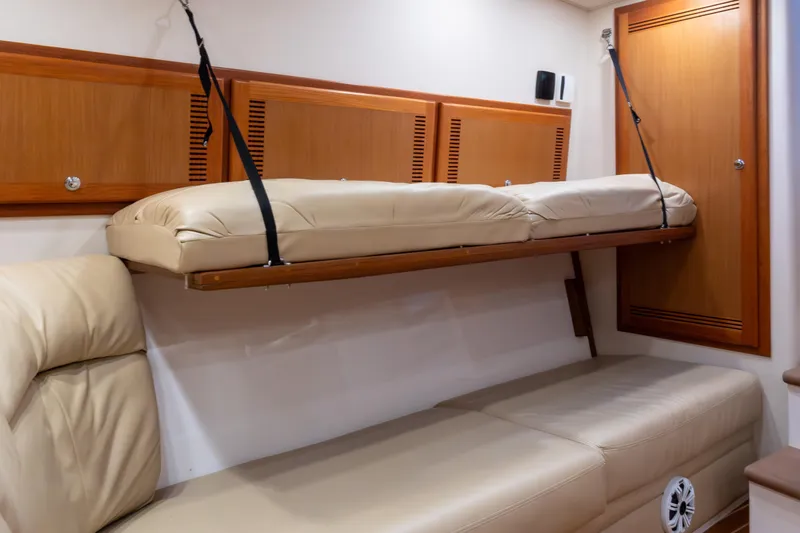  Yacht Photos Pics Interior of 2006 Cabo 40 Express yacht with beige leather seating and wooden cabinetry.