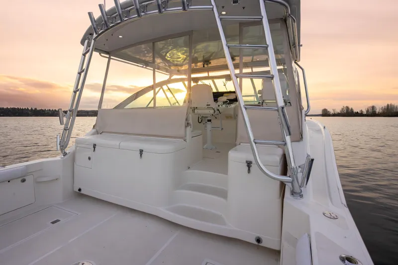  Yacht Photos Pics 2006 Cabo 40 Express boat at sunset on calm waters.