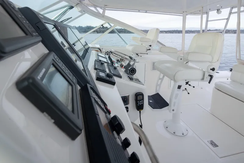  Yacht Photos Pics Interior of 2006 Cabo 40 Express yacht with modern navigation equipment and white seating.