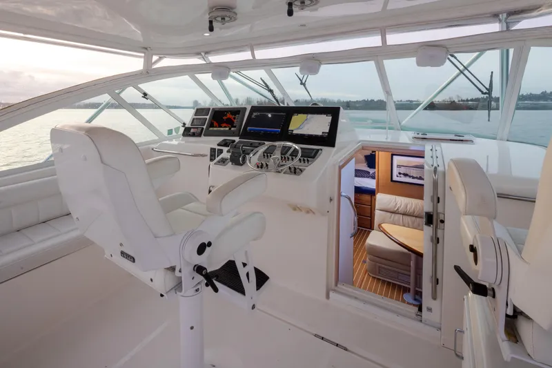  Yacht Photos Pics Interior of 2006 Cabo 40 Express yacht with modern navigation equipment and luxurious seating.
