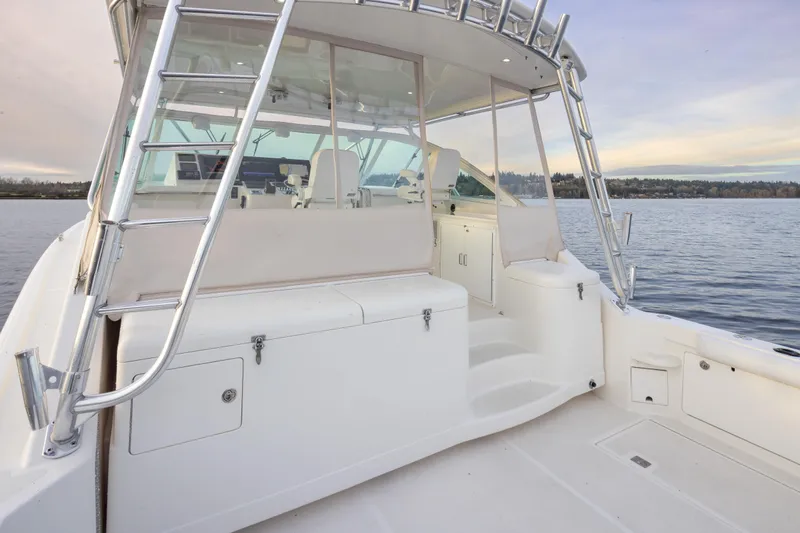  Yacht Photos Pics 2006 Cabo 40 Express boat interior with seating and ladder on calm water.