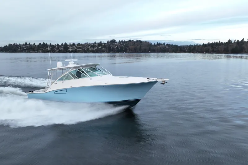  Yacht Photos Pics 2006 Cabo 40 Express Sportfish cruising on calm waters.