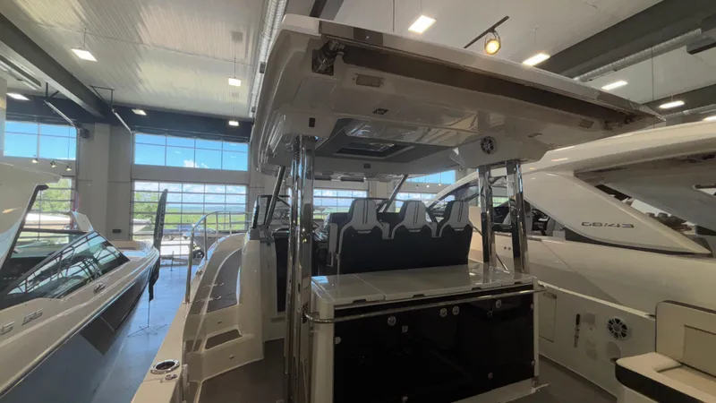  Yacht Photos Pics 2024 Jeanneau Leader 12.5 WA boat displayed in a showroom, featuring sleek design and modern amenities.