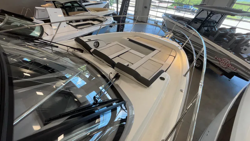 Yacht Photos Pics 2024 Jeanneau Leader 12.5 WA boat displayed in showroom, featuring sleek design and spacious deck.