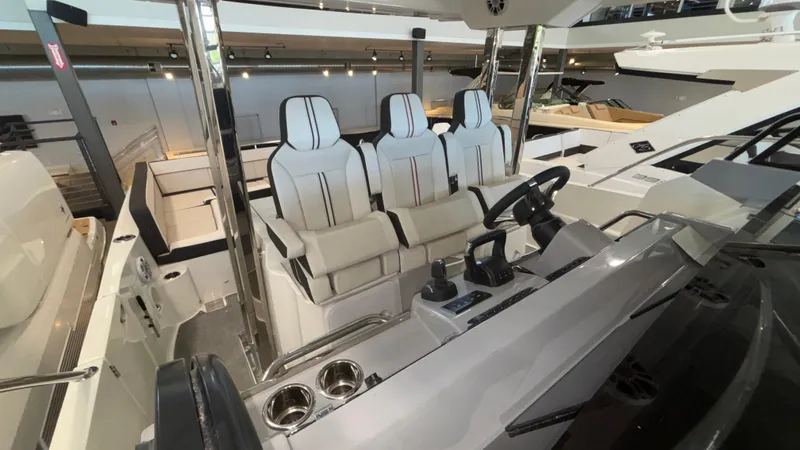  Yacht Photos Pics 2024 Jeanneau Leader 12.5 WA boat interior with modern seating and control panel.