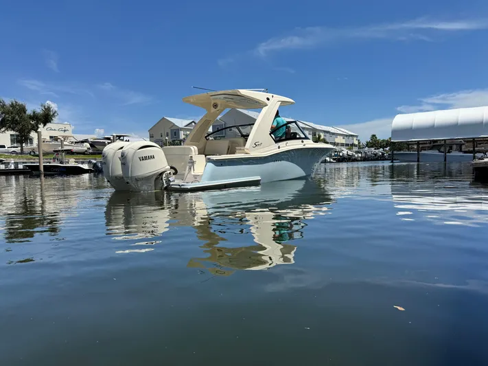  Yacht Photos Pics 2025 Scout 277 Dorado boat on calm water, featuring Yamaha outboard motor.