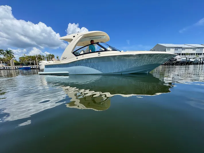  Yacht Photos Pics 2025 Scout 277 Dorado boat on calm water under clear blue sky.