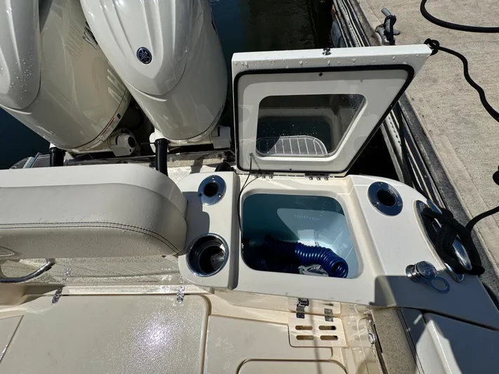  Yacht Photos Pics 2025 Scout 277 Dorado boat with open storage compartment and twin engines.
