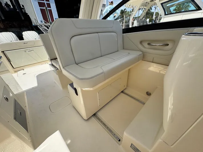  Yacht Photos Pics 2025 Scout 277 Dorado boat interior with beige seating and storage compartments.