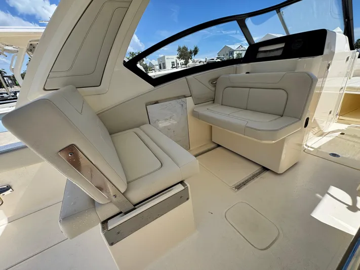  Yacht Photos Pics 2025 Scout 277 Dorado boat interior with beige seating and modern design.