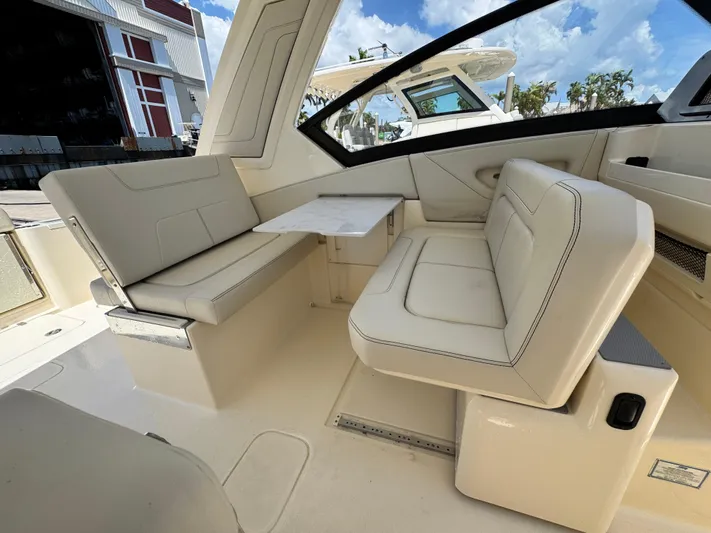  Yacht Photos Pics 2025 Scout 277 Dorado boat interior with beige seating and table.
