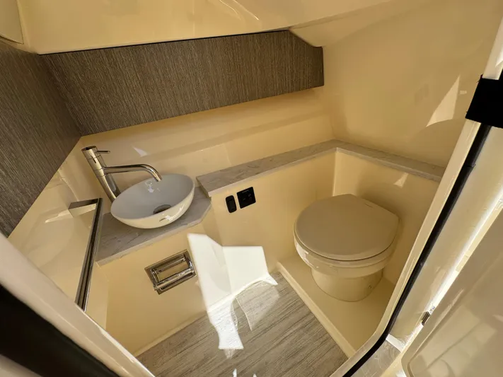  Yacht Photos Pics Luxurious bathroom in 2025 Scout 277 Dorado boat with modern sink and toilet.