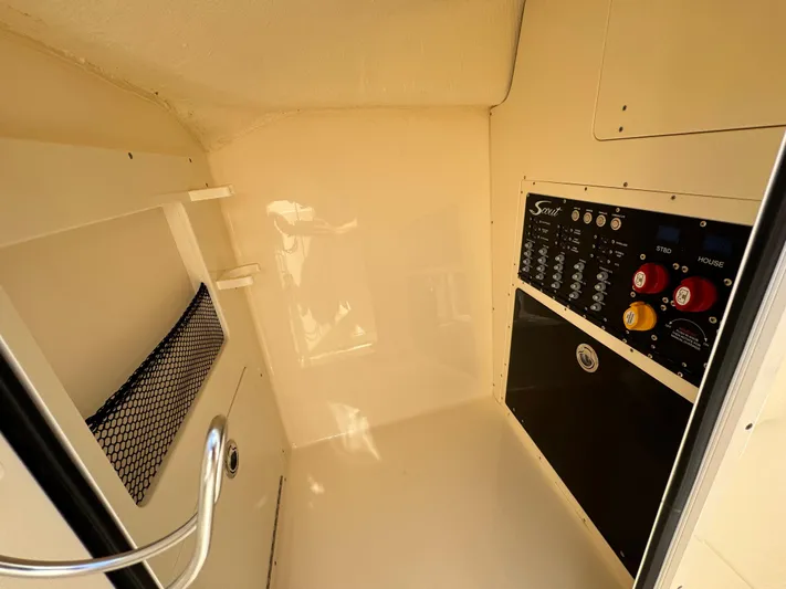  Yacht Photos Pics 2025 Scout 277 Dorado interior with control panel and storage net.