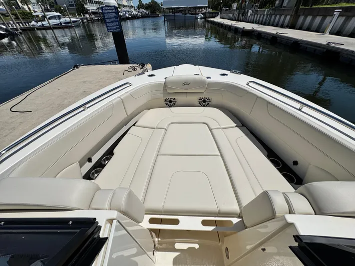  Yacht Photos Pics 2025 Scout 277 Dorado boat interior with luxurious seating at a marina dock.