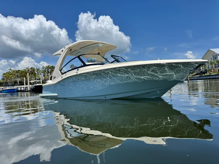  Yacht Photos Pics 2025 Scout 277 Dorado boat on calm water under a clear blue sky.