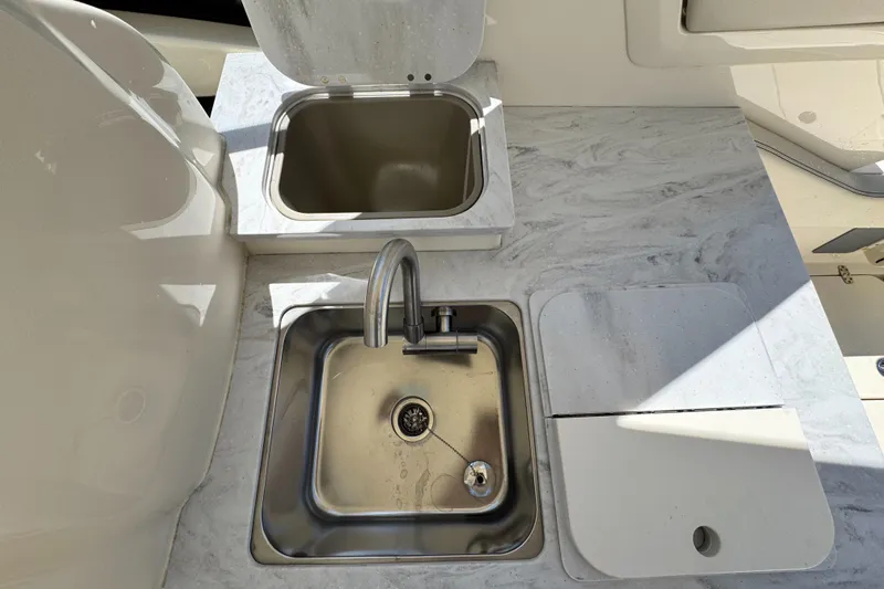  Yacht Photos Pics 2025 Scout 277 Dorado boat kitchen with stainless steel sink and countertop.