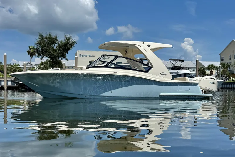  Yacht Photos Pics 2025 Scout 277 Dorado boat on calm water under a clear blue sky.