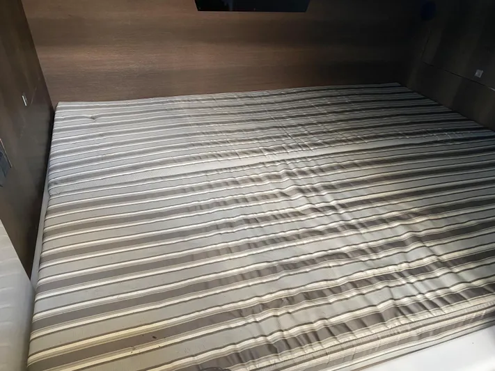  Yacht Photos Pics Striped mattress in the cabin of a 2019 Monterey 378 Super Express boat.