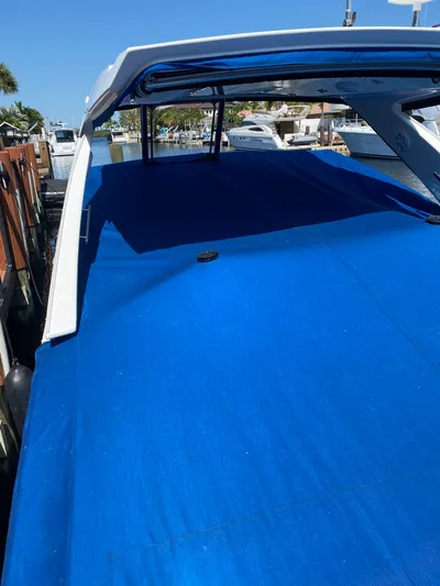  Yacht Photos Pics 2019 Monterey 378 Super Express boat with blue cover docked at marina.