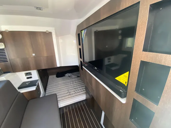  Yacht Photos Pics Interior cabin of a 2019 Monterey 378 Super Express with TV and bed.