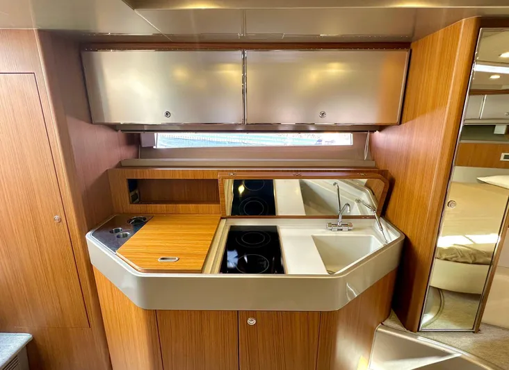  Yacht Photos Pics Luxurious 2003 Riva RivaRama 44 yacht interior with modern kitchen and wooden cabinetry.
