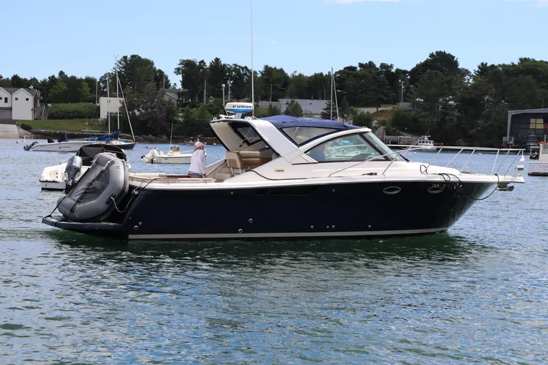 Cara Mia Yacht Photos Pics 2012 Tiara Yachts 3100 Coronet cruising on a calm lake with scenic background.