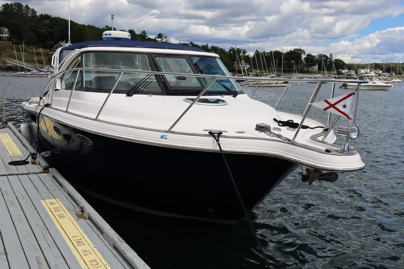 Cara Mia Yacht Photos Pics 2012 Tiara Yachts 3100 Coronet docked in a marina, under a partly cloudy sky.
