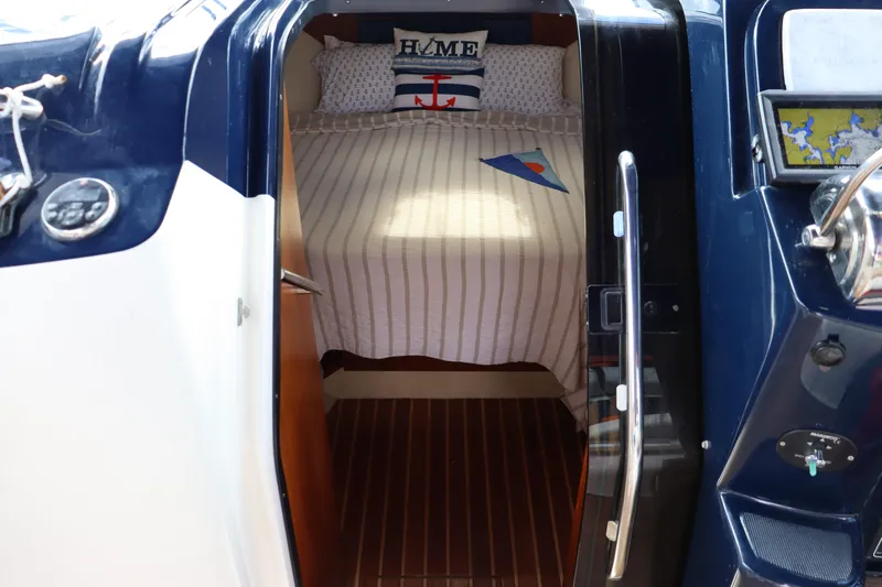 Cara Mia Yacht Photos Pics Cabin interior of 2012 Tiara Yachts 3100 Coronet with nautical-themed bedding.