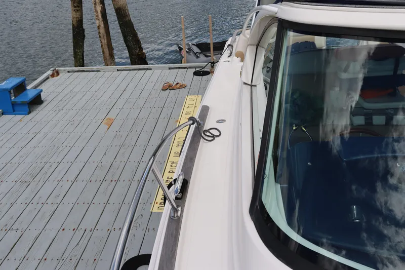 Cara Mia Yacht Photos Pics 2012 Tiara Yachts 3100 Coronet docked by a wooden pier.